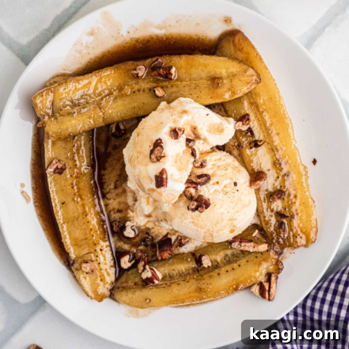 An overhead shot of a plate of Bananas Foster, featuring caramelized bananas, a scoop of vanilla ice cream, and a rich rum sauce.