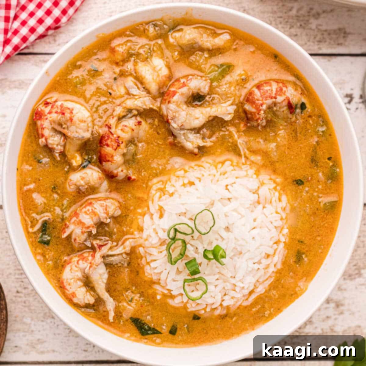 A generous bowl of creamy Crawfish Etouffee, with a scoop of rice in the center.