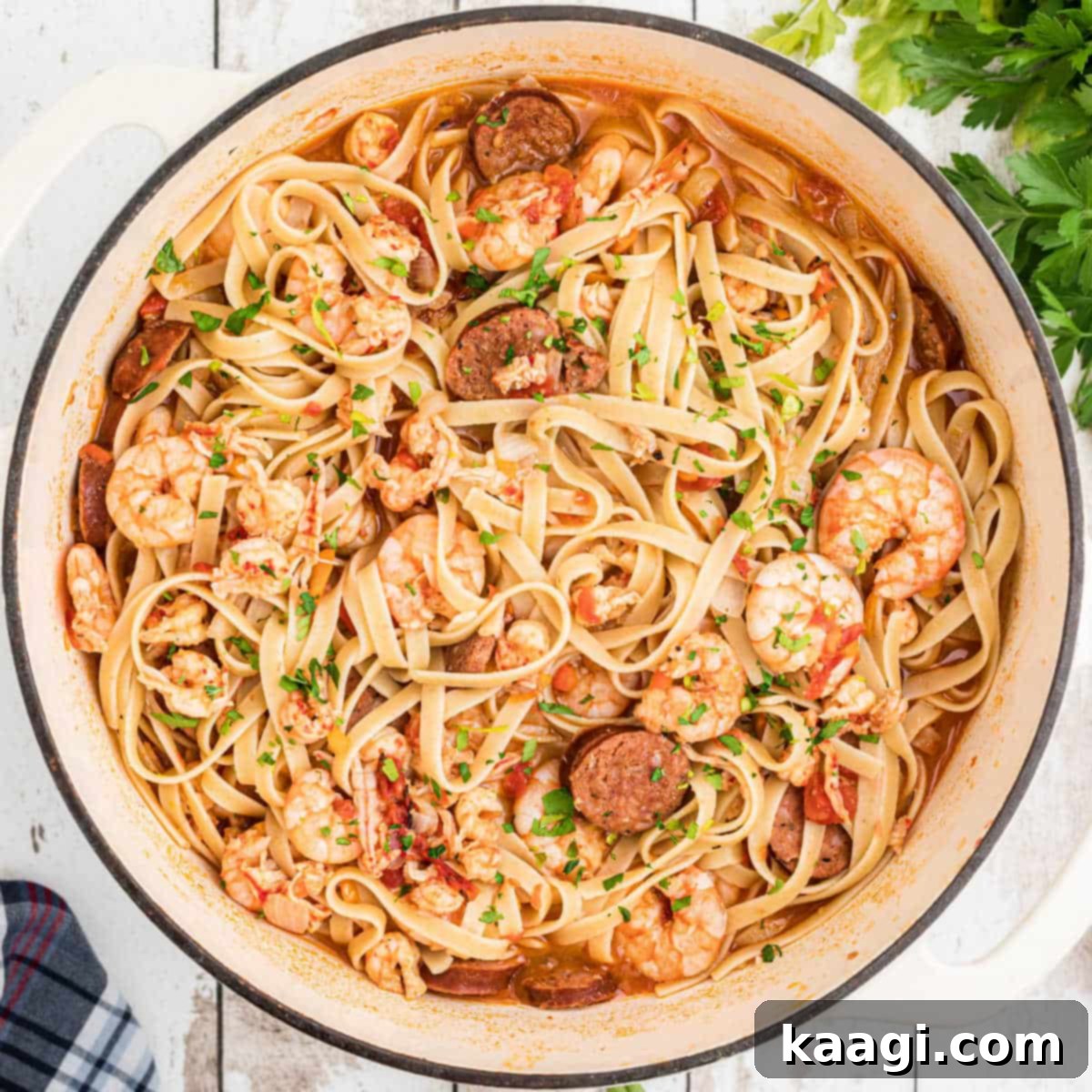 An overhead shot of a large pot filled with rich Shrimp and Crawfish Pastalaya, a pasta take on jambalaya.
