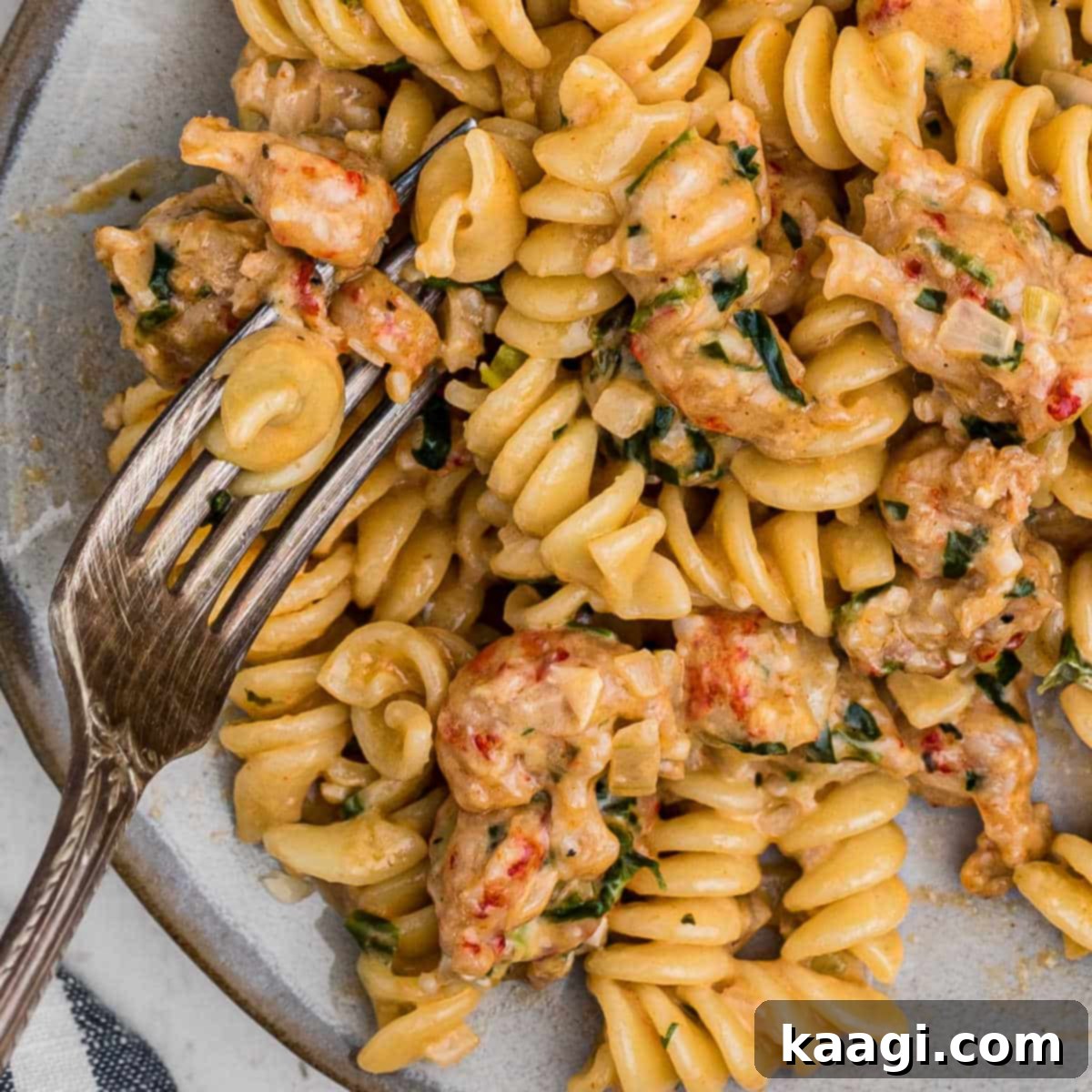 A close-up of a bowl of creamy Crawfish Monica, with a fork digging in.