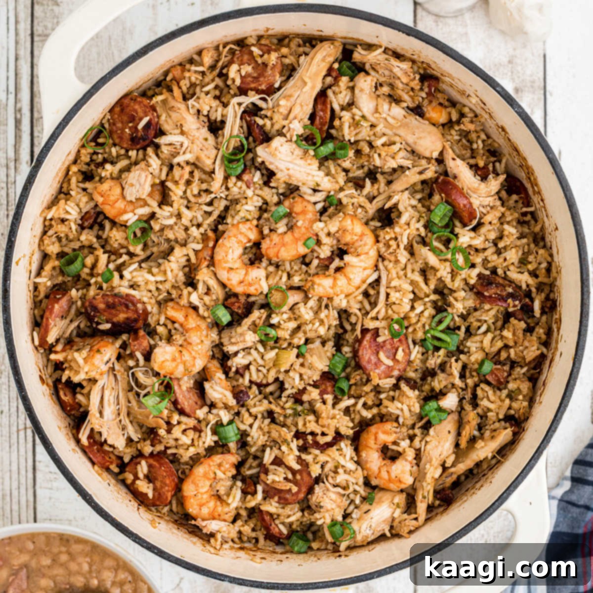 An overhead shot of a Dutch Oven Jambalaya, showcasing the perfectly cooked rice, sausage, and shrimp.