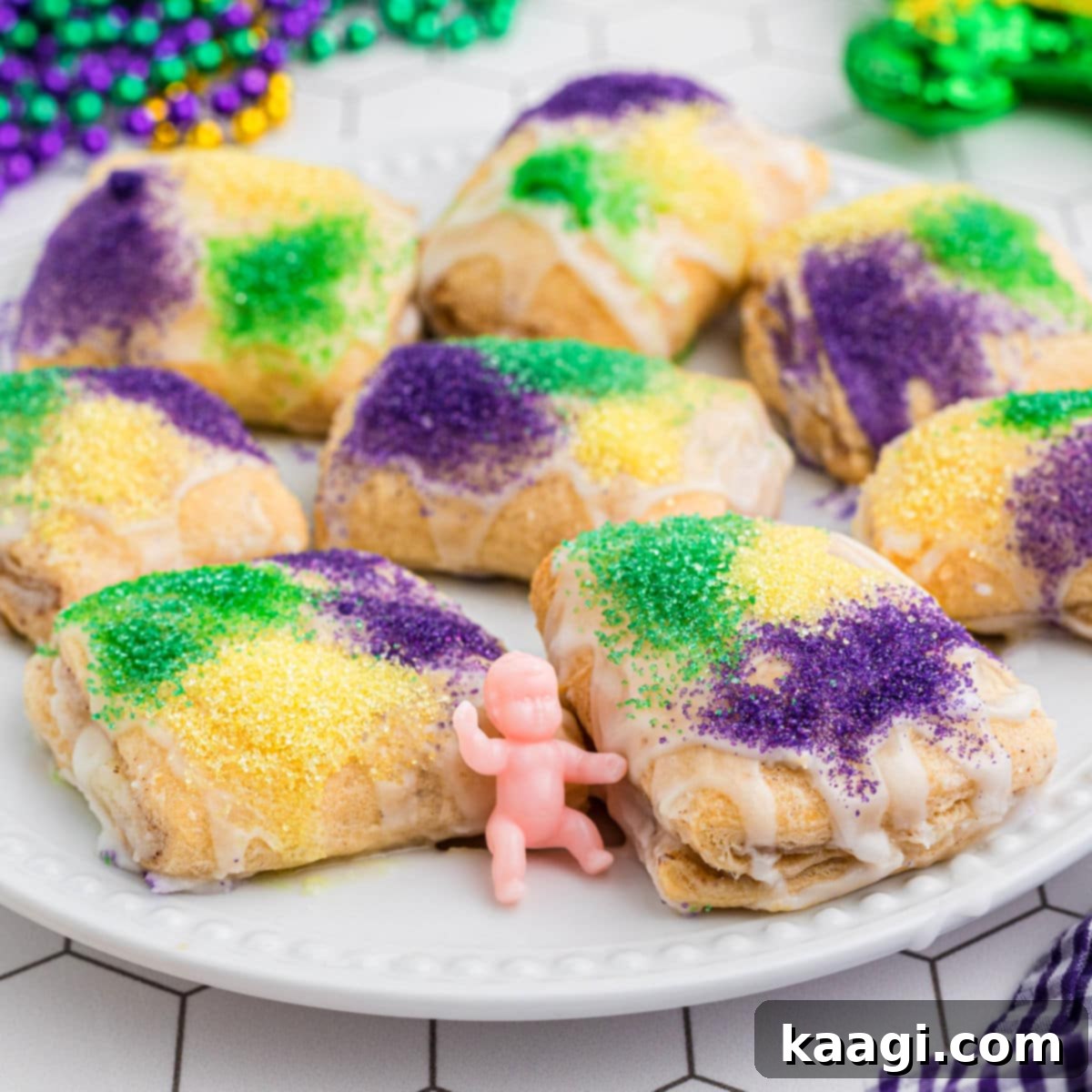 Small, square King Cake Bites, beautifully decorated and ready to be enjoyed.