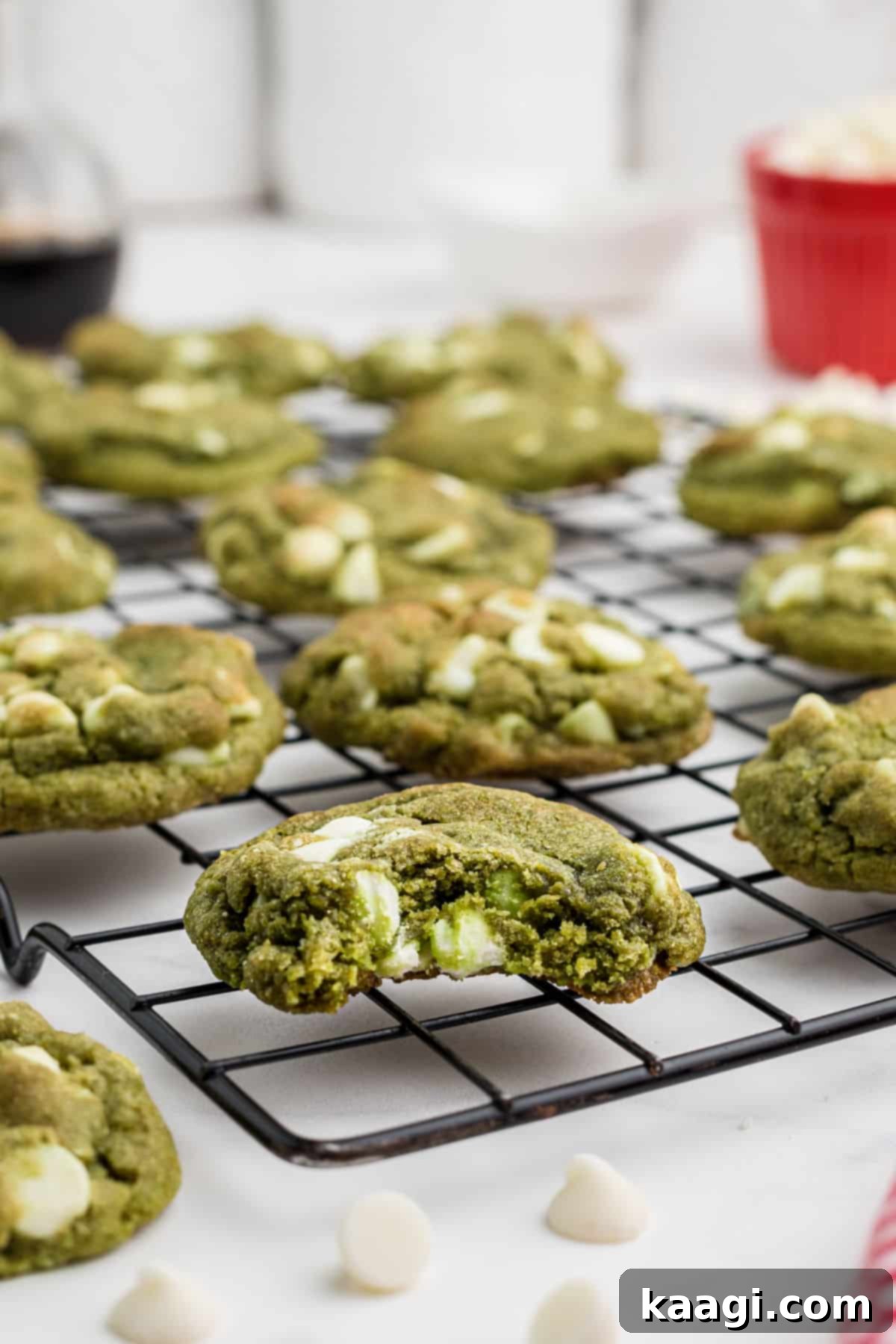 Emerald Matcha Delights 2 Close up shot of a matcha cookie with a bite taken out, showcasing its vibrant green color and soft texture.